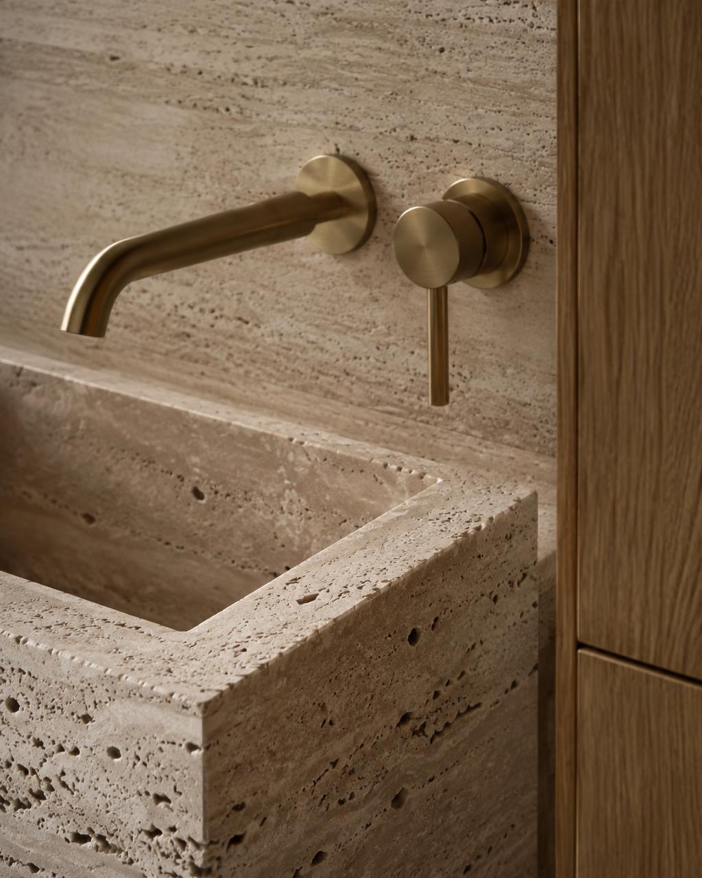 Travertine basin and brass tap